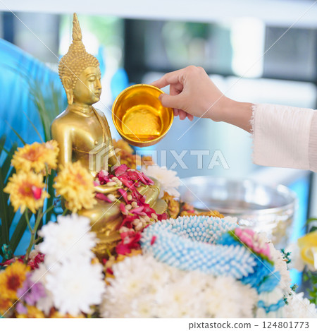 Happy Songkran festival day in Thailand or Thai Happy New Year. hand pouring water on golden Buddha statue with flowers and garland in. Holiday and culture concept Happy Songkran festival day in 124801773