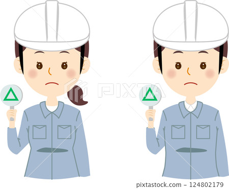 A man and a woman in blue work clothes holding up a triangular sign 124802179