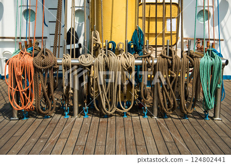 Marine equipment on the deck of a ship. Marine ropes and different tackles. 124802441