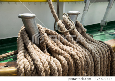 Marine equipment on the deck of a ship. Marine ropes and different tackles. 124802442