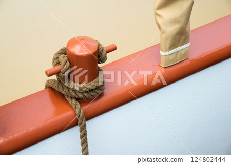 Marine equipment on the deck of a ship. Marine ropes and different tackles. 124802444