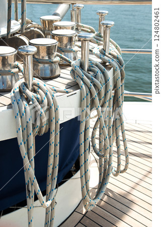Marine equipment on the deck of a ship. Marine ropes and different tackles. Marine equipment on the deck of a ship. Marine ropes and different tackles. 124802461