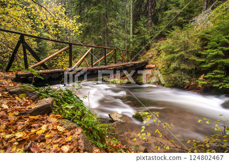 Canyon of Waterfalls, Rhodope Mountains, Bulgaria, Europe. Long exposure of flowing river and wooden bridge. Canyon of Waterfalls, Rhodope Mountains, Bulgaria, Europe. Long exposure of flowing river and wooden bridge. 124802467