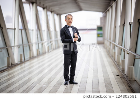Portrait of a senior man walking in a business district Portrait of a senior man walking in a business district 124802581