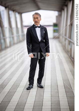 Portrait of a senior man walking in a business district Portrait of a senior man walking in a business district 124802582