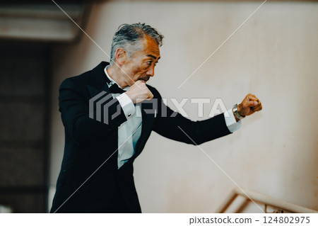 Senior man fighting, throwing punches 124802975