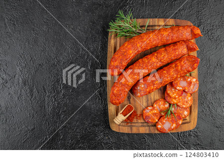 Set of Salami, chorizo, Meat antipasto platter on black background. Top view Set of Salami, chorizo, Meat antipasto platter on black background. Top view 124803410