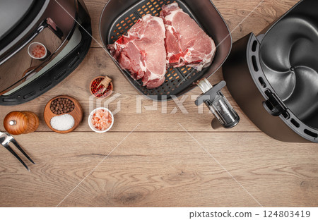 Two grilled steaks from air fryer oven on a wooden background, top view. copy space 124803419