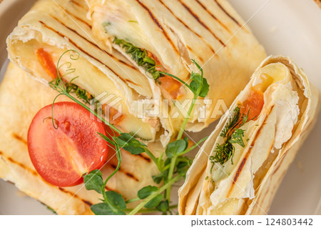 Wrap sandwich grilled with feta cheese. Top view 124803442