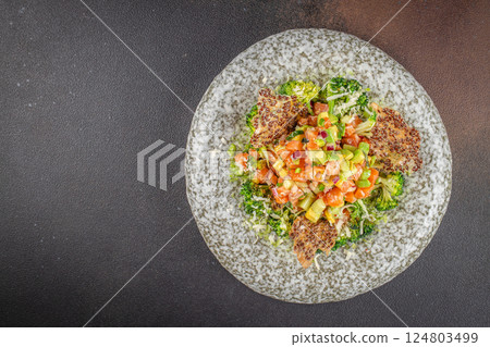 Delicious avocado and raw salmon salad, tartare. on a dark background. top view. copy space for text 124803499