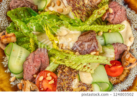 beef steak medium rare, fresh greens and vegetable salad. Food recipe background. Close up. top view beef steak medium rare, fresh greens and vegetable salad. Food recipe background. Close up. top view 124803502