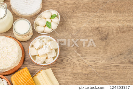 dairy and dairy products on wooden background. Milk, sour cream, mozzarella, kefir, yogurt, cheese assortment. top view. copy space dairy and dairy products on wooden background. Milk, sour cream, mozzarella, kefir, yogurt, cheese assortment. top view. copy space 124803527