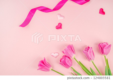 Beautiful tulip flowers and ribbon on pink background. Celebrating Valentine's Day and Mother's Day. top view. copy space 124803581