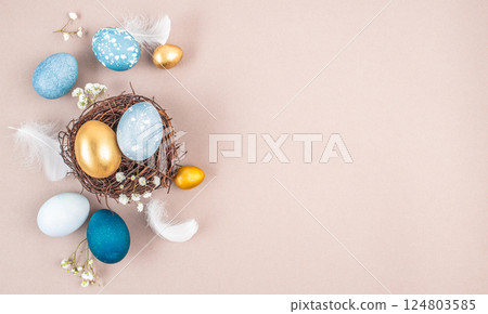 decorations, easter eggs in a nest on a beige background. Happy easter flat lay concept. decorations, easter eggs in a nest on a beige background. Happy easter flat lay concept. 124803585