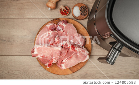 Raw steak meat with spices ready to cook in air fryer. copy space, top view 124803588