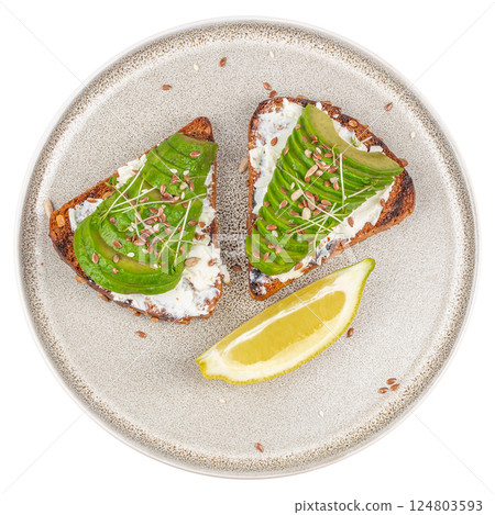 Healthy avocado toasts with rye bread, sliced avocado, cheese. isolated on white background. top view 124803593