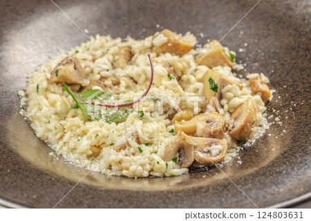 risotto with brown champignon mushrooms and white wine. dish of Italian cuisine risotto with brown champignon mushrooms and white wine. dish of Italian cuisine 124803631