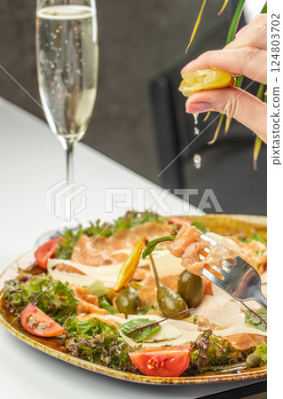 Salmon carpaccio with champagne, salad salmon appetizer served on a plate, copy space 124803702