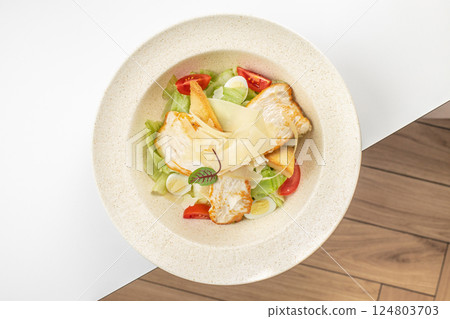 A delicious chicken caesar salad with chicken on white background. top view 124803703