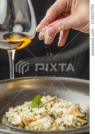 risotto with brown champignon mushrooms and white wine. dish of Italian cuisine 124803704