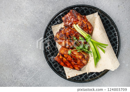 A grilled pork ribs Barbecue on plate on a light background, top view. copy space 124803709