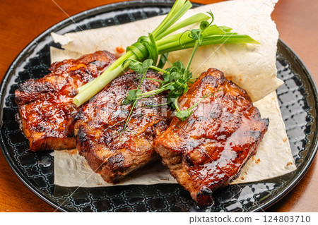 hot grilled spare ribs glazed in BBQ sauce. Food recipe background. Close up. top view 124803710