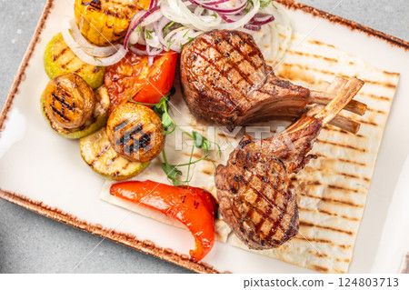 Grilled lamb chop steak with vegetable. Delicious juicy meat on the bone or rack. copy space Grilled lamb chop steak with vegetable. Delicious juicy meat on the bone or rack. copy space 124803713