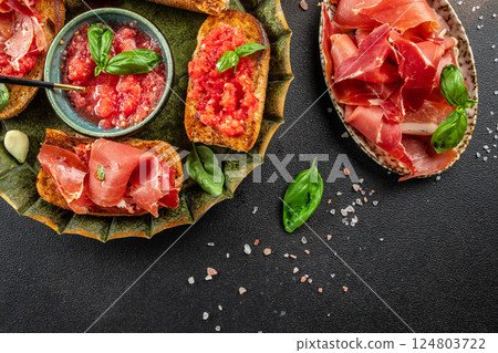 tomato toast with oil, jamon and tomato, traditional Spanish breakfast or lunch. Concept healthy and balanced eating. place for text, top view tomato toast with oil, jamon and tomato, traditional Spanish breakfast or lunch. Concept healthy and balanced eating. place for text, top view 124803722