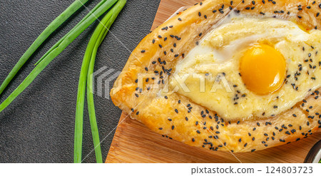 Khachapuri with egg on wooden background. Georgian cuisine. top view. copy space for text 124803723