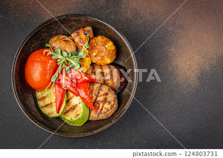 Grilled vegetables in plate colorful bell pepper, zucchini, eggplant on a dark background. top view. copy space for text 124803731