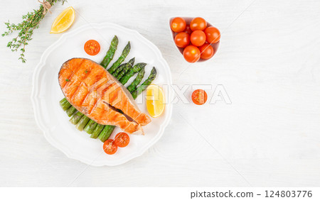 grilled Salmon Fish Steak asparagus on white background, top view 124803776