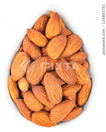 dried almond nuts in white bowl isolated on white background. top view 124803781