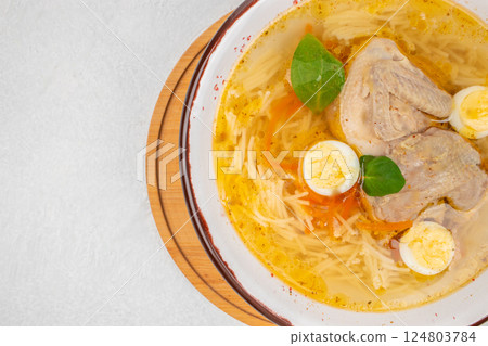 Quail broth or soup in a bowl on a white background top view. copy space Quail broth or soup in a bowl on a white background top view. copy space 124803784