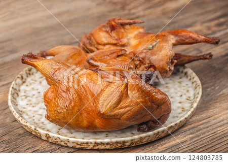 meat smoked quail with herbs on a wooden background meat smoked quail with herbs on a wooden background 124803785