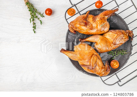hot smoked quails with herbs and spices on a light background, ecological farm products. top view. copy space hot smoked quails with herbs and spices on a light background, ecological farm products. top view. copy space 124803786