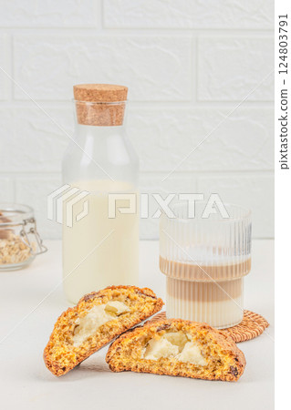 healthy homemade oat cookies with cheese filling, glass of latte on a light background. space for text 124803791