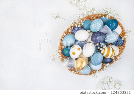 Easter eggs with blossoms spring flowers in basket on a white background. Easter card. top view. copy space Easter eggs with blossoms spring flowers in basket on a white background. Easter card. top view. copy space 124803831