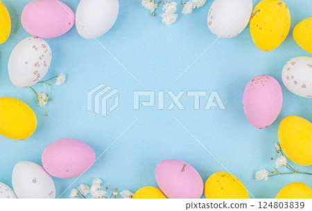 Colorful Easter Egg side border over a pastel blue paper background. Copy space Colorful Easter Egg side border over a pastel blue paper background. Copy space 124803839