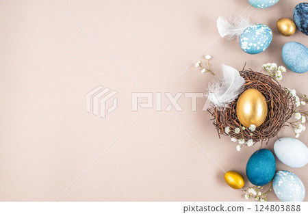 decorations, easter eggs in a nest on a beige background. Happy easter flat lay concept 124803888