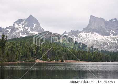 Two mountain peaks, coniferous forest and lake Two mountain peaks, coniferous forest and lake 124805294
