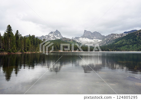 Spring mountains landscape. Two mountain peaks, coniferous forest and lake 124805295