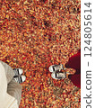 Feet with shoes on fallen leaves 124805614