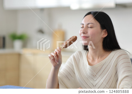 Asian woman enjoying ready to eat ice cream 124805888