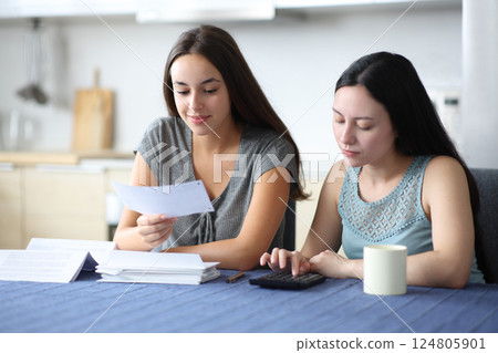 Interraciel roommates calculating expenses holding bill 124805901