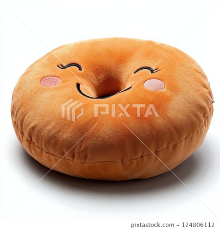 Cute smiling donut pillow with adorable cartoon face on soft orange fabric for cozy home decor or kids room 124806112