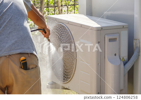 air conditioning compressor outdoor unit cleaning service with water spray 124806258