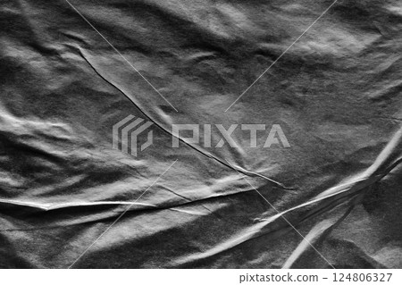 Black crumpled and creased paper poster grunge texture background Black crumpled and creased paper poster grunge texture background 124806327