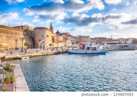 Unbelivable summer view of the Alghero Marina yacht port at the Gulf of Alghero with anchored sailboats. 124807091