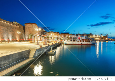 Unbelivable Night view of the Alghero Marina yacht port at the Gulf of Alghero with anchored sailboats 124807108