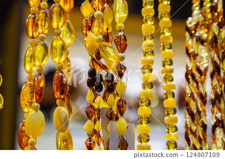 Amber Beads in a Street Shop. Orange Baltic Sea Souvenir, Natural Jewelry, Gold Brown Stone Necklace Amber Beads in a Street Shop. Orange Baltic Sea Souvenir, Natural Jewelry, Gold Brown Stone Necklace 124807109